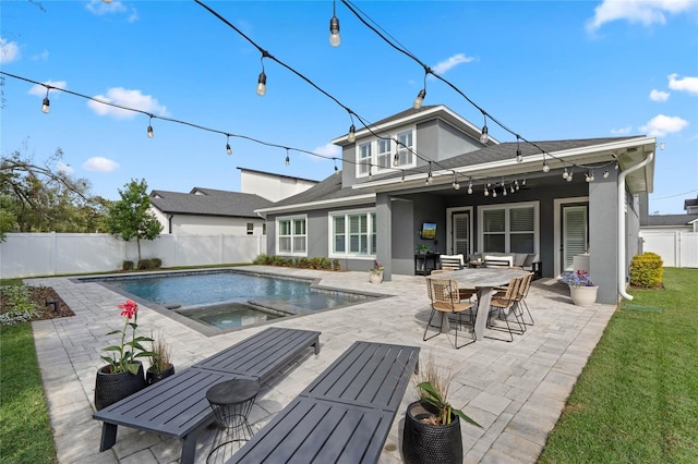 rear view of property featuring a fenced in pool, a patio, a balcony, a fenced backyard, and stucco siding