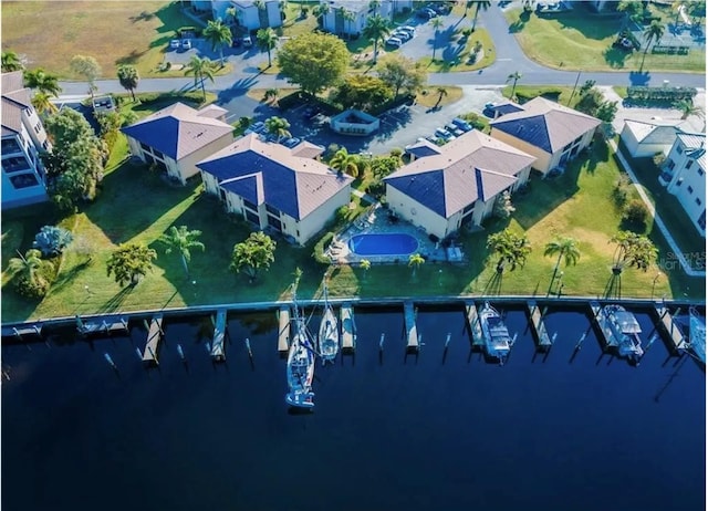 drone / aerial view with a water view and a residential view