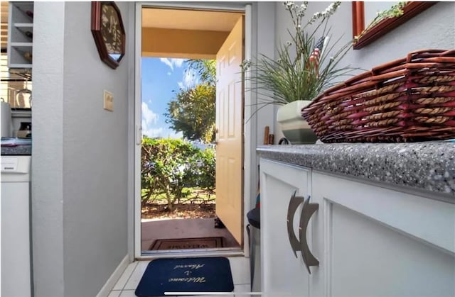 doorway to outside featuring light tile patterned floors