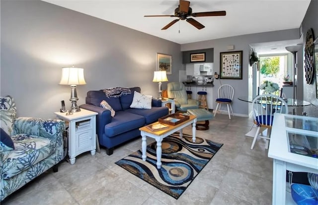 living room featuring ceiling fan and baseboards