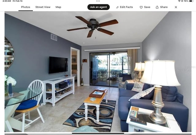 living room featuring visible vents and a ceiling fan