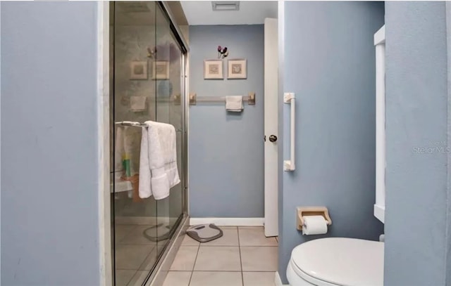 bathroom with toilet, visible vents, baseboards, tile patterned floors, and a stall shower