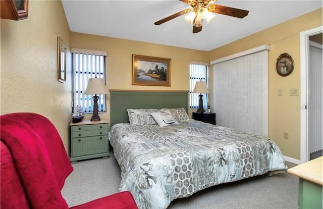 bedroom with carpet, baseboards, ceiling fan, and a closet