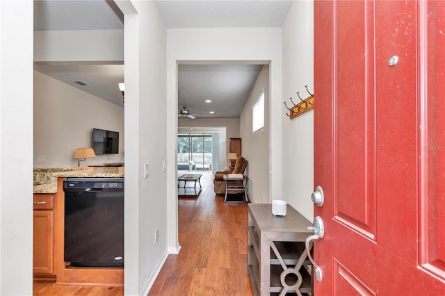 foyer entrance featuring ceiling fan, visible vents, light wood-style flooring, and baseboards