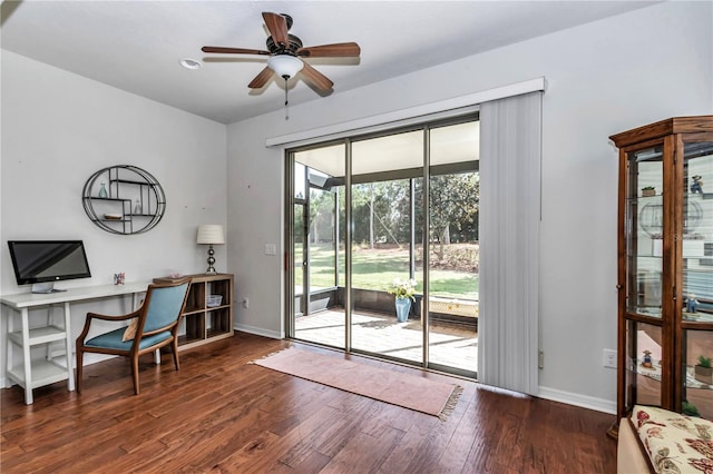 office area featuring a sunroom, wood finished floors, a ceiling fan, and baseboards