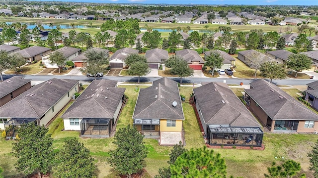 bird's eye view featuring a water view and a residential view