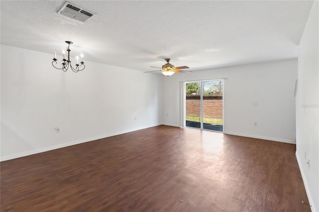 spare room with a textured ceiling, ceiling fan with notable chandelier, dark wood-style flooring, visible vents, and baseboards