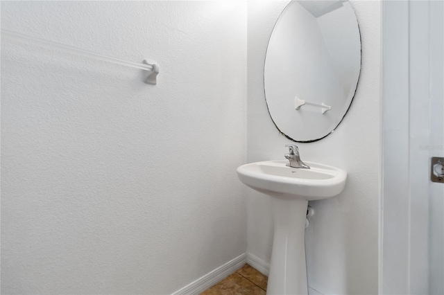 bathroom with tile patterned flooring and baseboards