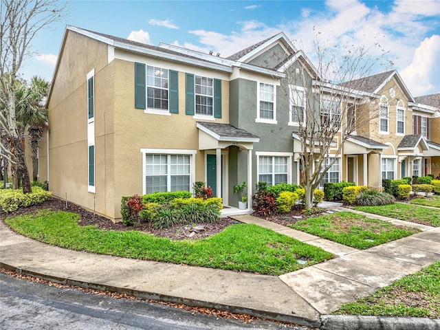 townhome / multi-family property featuring stucco siding