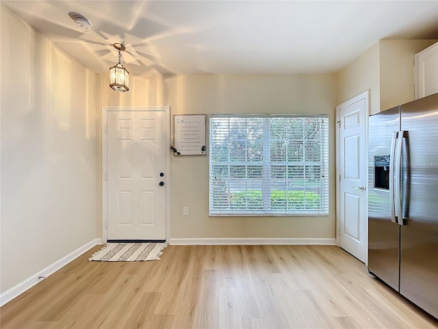 1410 Stockton Dr, Sanford, FL 32771 - foyer entrance featuring light wood-style flooring and baseboards