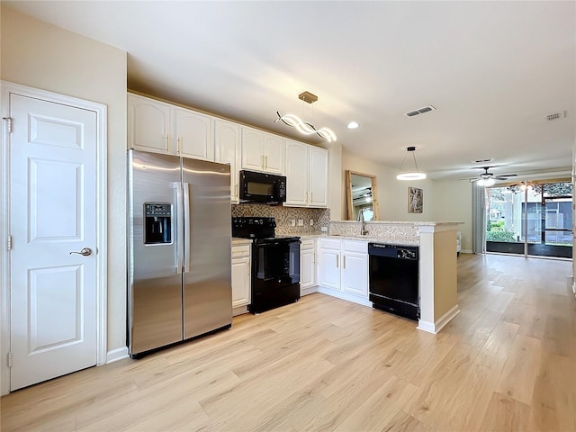 1410 Stockton Dr, Sanford, FL 32771 - kitchen with visible vents, backsplash, a sink, a peninsula, and black appliances