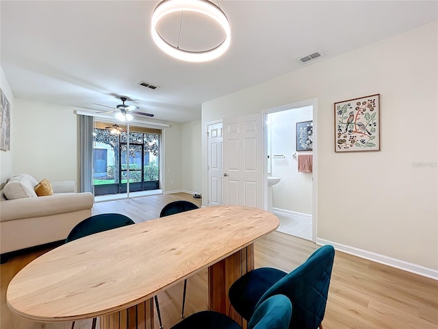 1410 Stockton Dr, Sanford, FL 32771 - dining room with light wood-style flooring, visible vents, and baseboards