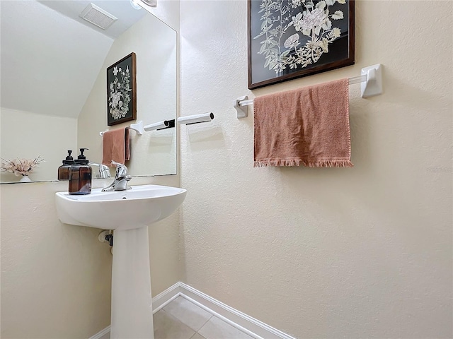 1410 Stockton Dr, Sanford, FL 32771 - bathroom with visible vents, vaulted ceiling, baseboards, and tile patterned floors