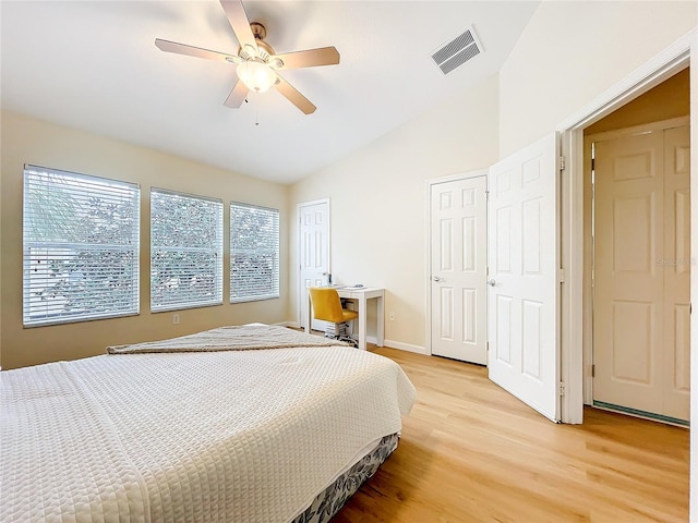 1410 Stockton Dr, Sanford, FL 32771 - bedroom with lofted ceiling, a ceiling fan, light wood-style floors, visible vents, and multiple closets