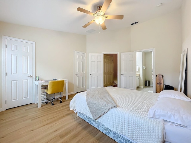 1410 Stockton Dr, Sanford, FL 32771 - bedroom with light wood finished floors, visible vents, a ceiling fan, connected bathroom, and two closets