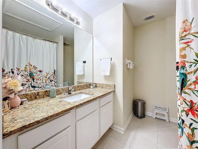 1410 Stockton Dr, Sanford, FL 32771 - bathroom with toilet, vanity, baseboards, visible vents, and tile patterned floors