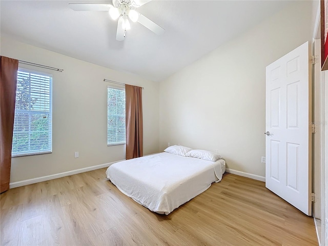 1410 Stockton Dr, Sanford, FL 32771 - bedroom with light wood-style flooring, baseboards, vaulted ceiling, and a ceiling fan