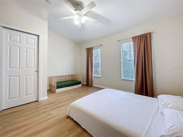 1410 Stockton Dr, Sanford, FL 32771 - bedroom with light wood-type flooring, ceiling fan, baseboards, and lofted ceiling