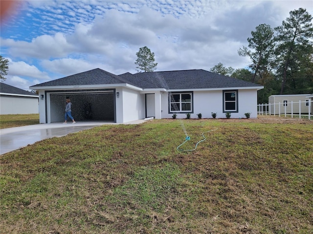 ranch-style house featuring a garage, stucco siding, concrete driveway, and a front yard