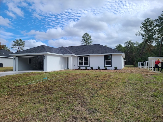 single story home with a garage, fence, concrete driveway, stucco siding, and a front yard