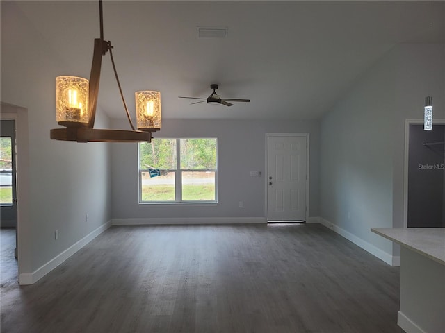 unfurnished living room with visible vents, baseboards, dark wood finished floors, a ceiling fan, and lofted ceiling