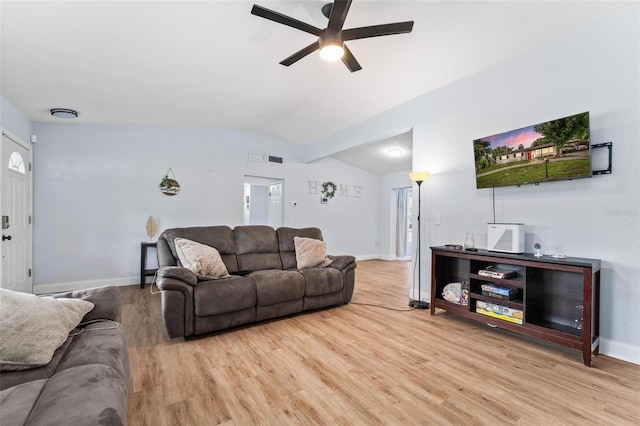 living room featuring lofted ceiling, ceiling fan, wood finished floors, visible vents, and baseboards