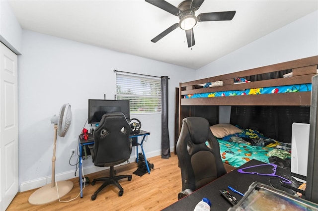 bedroom with ceiling fan, baseboards, vaulted ceiling, and wood finished floors