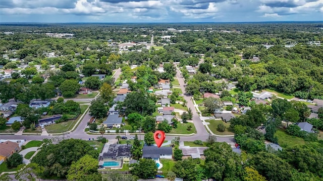 birds eye view of property featuring a view of trees