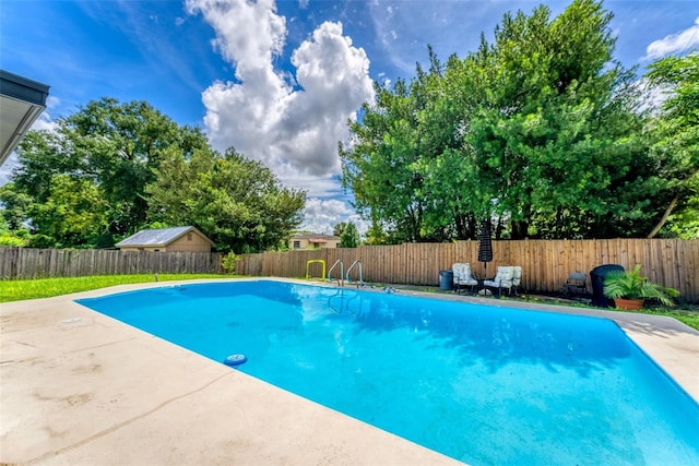 view of swimming pool featuring a patio area, a fenced backyard, and a fenced in pool