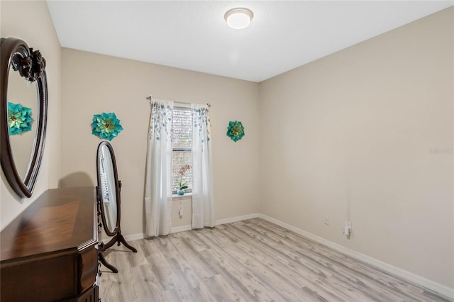 office featuring light wood-type flooring and baseboards