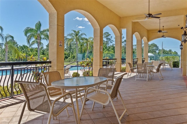 view of patio / terrace featuring a ceiling fan, outdoor dining area, and a fenced in pool