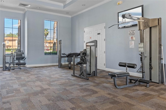 exercise room featuring carpet, visible vents, baseboards, and ornamental molding