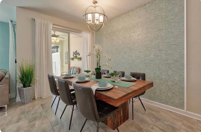 dining space featuring a notable chandelier and baseboards