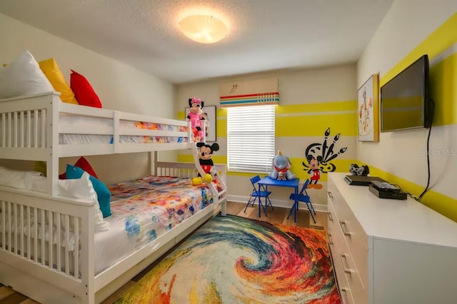 bedroom with wood finished floors and baseboards