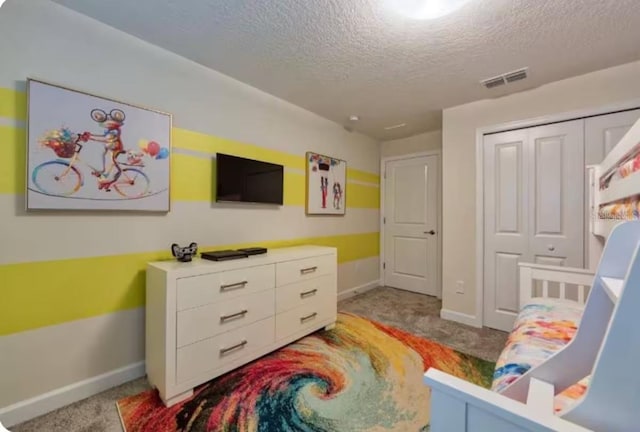 bedroom with a textured ceiling, baseboards, visible vents, and light colored carpet