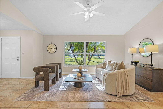 living room with light tile patterned floors, baseboards, a ceiling fan, and lofted ceiling