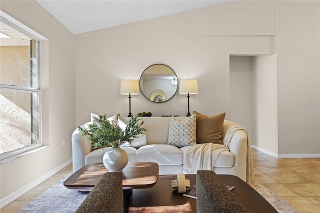 living area with lofted ceiling, light tile patterned flooring, and baseboards