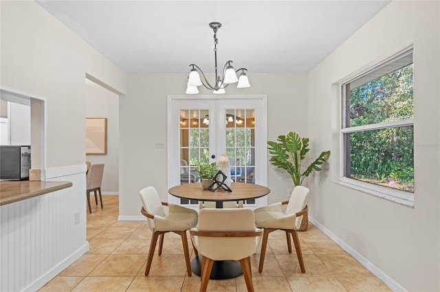 dining area with light tile patterned floors, a chandelier, and a healthy amount of sunlight