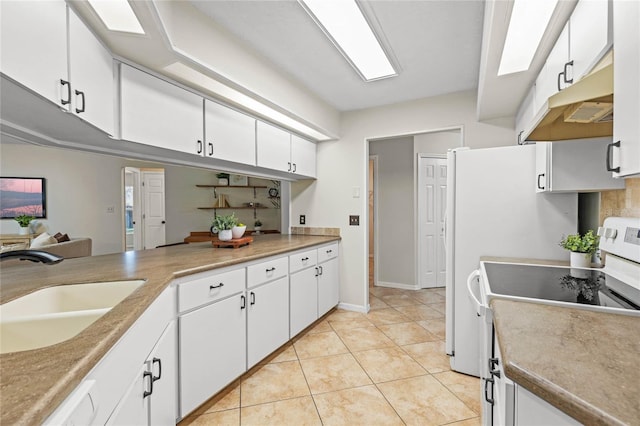 kitchen featuring under cabinet range hood, light tile patterned flooring, white appliances, white cabinetry, and a sink