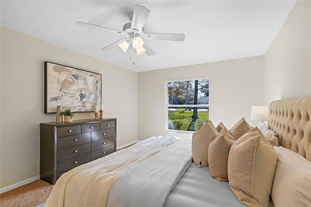 carpeted bedroom with baseboards and a ceiling fan