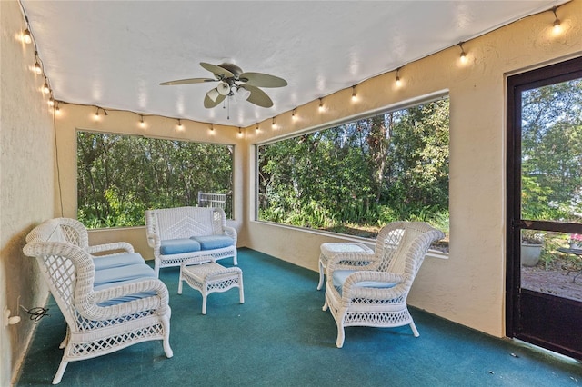 sunroom featuring a healthy amount of sunlight and a ceiling fan