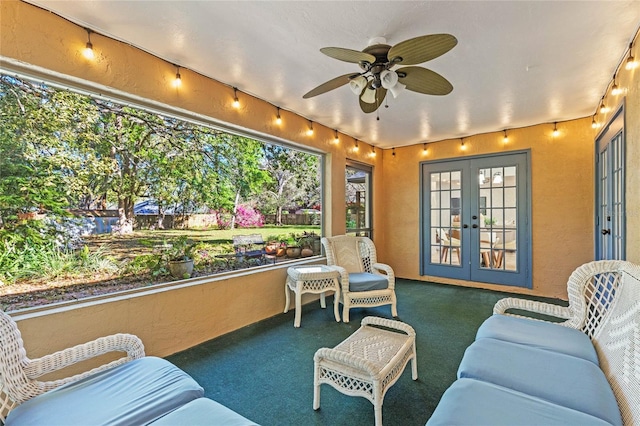 sunroom / solarium featuring french doors and ceiling fan