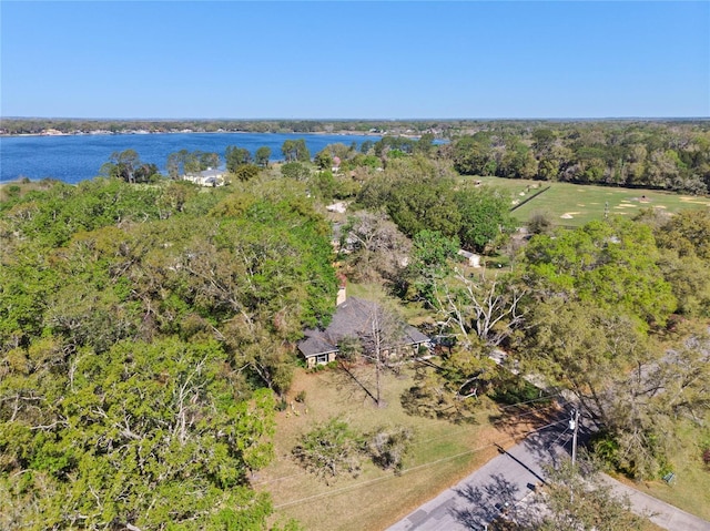 birds eye view of property featuring a forest view and a water view