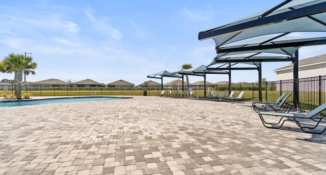 view of home's community featuring a swimming pool, fence, and a patio