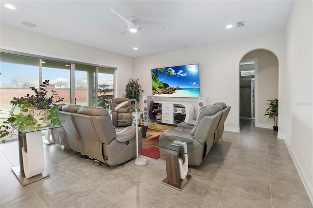 living room with visible vents, arched walkways, baseboards, ceiling fan, and recessed lighting