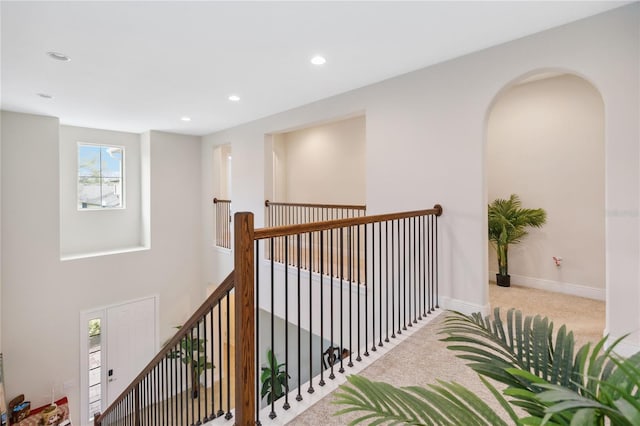 corridor with light carpet, recessed lighting, an upstairs landing, and baseboards