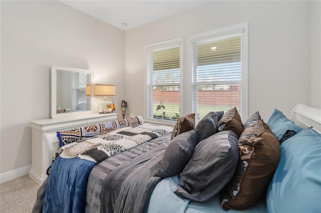 carpeted bedroom with baseboards