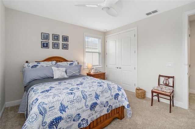 bedroom featuring light colored carpet, a closet, visible vents, and baseboards