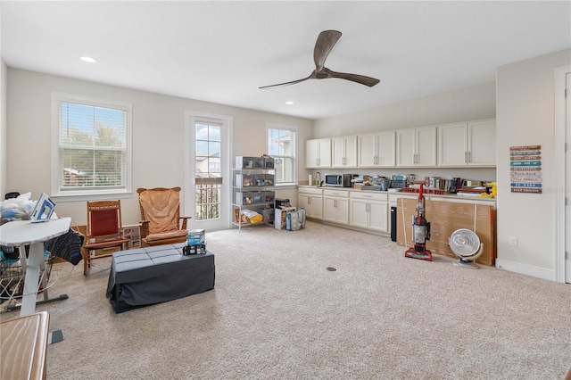 interior space with baseboards, recessed lighting, a ceiling fan, and light colored carpet