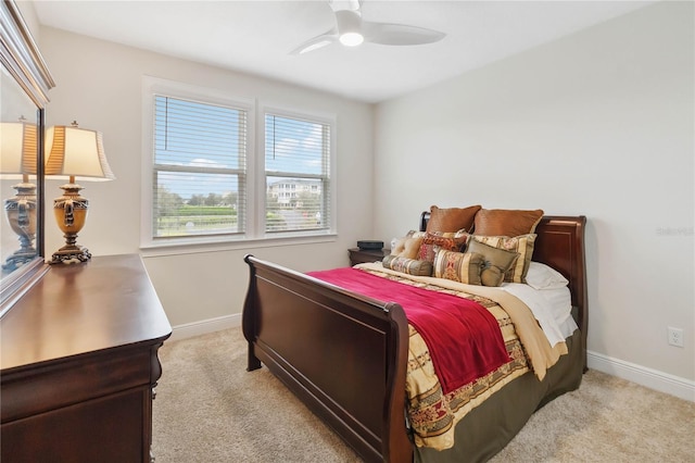 bedroom featuring baseboards, a ceiling fan, and light colored carpet